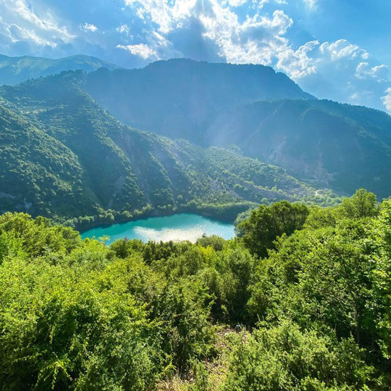 Turquoise lake among forested mountains of the Agrafa range, Greece