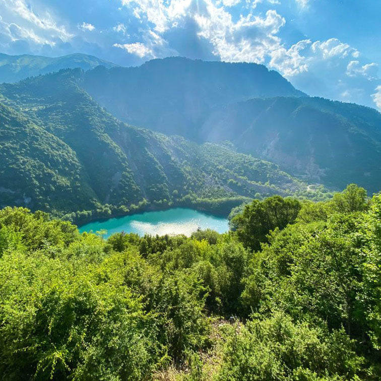 Turquoise lake among forested mountains of the Agrafa range, Greece