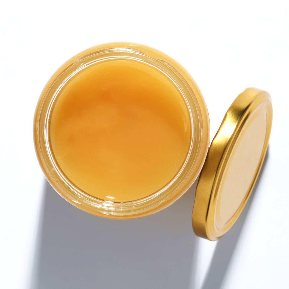 Raw Rapeseed Honey in an open jar, top view – Earthbreath