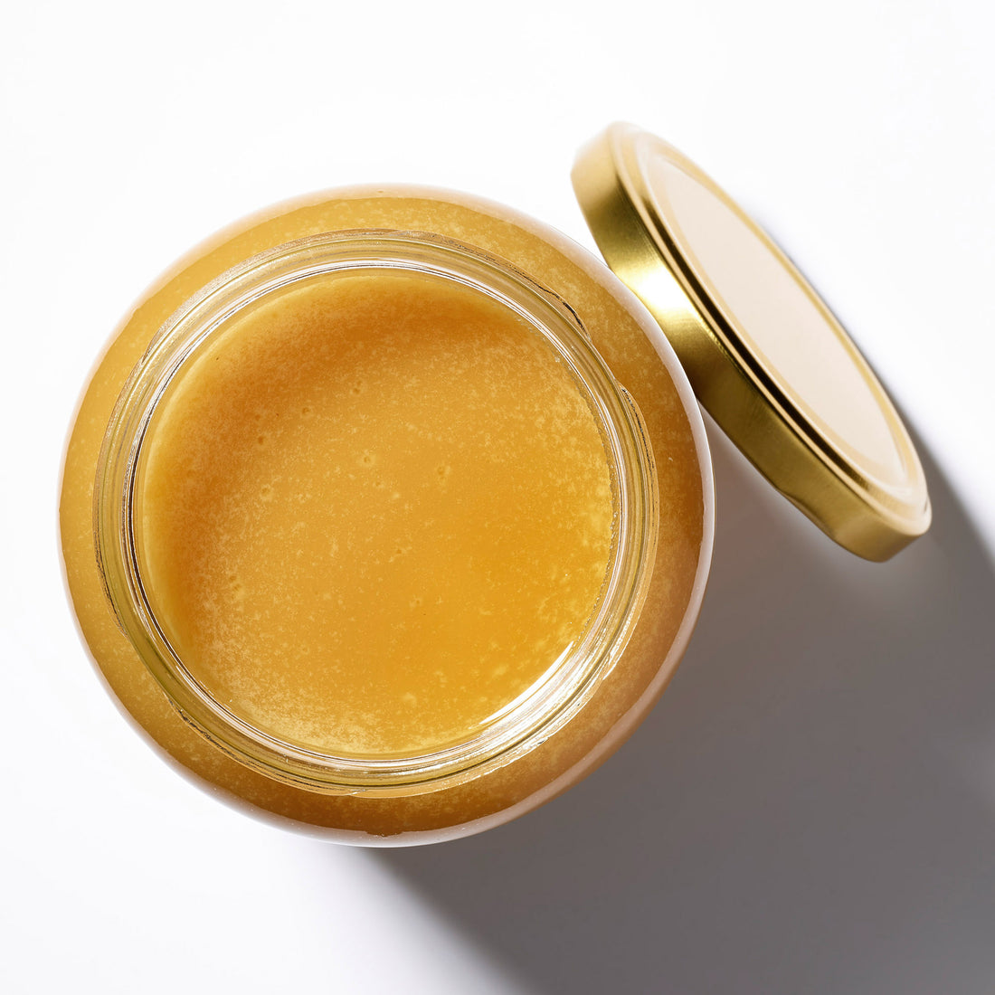 Organic Raw Forest Flower Honey in an open jar, top view – Earthbreath