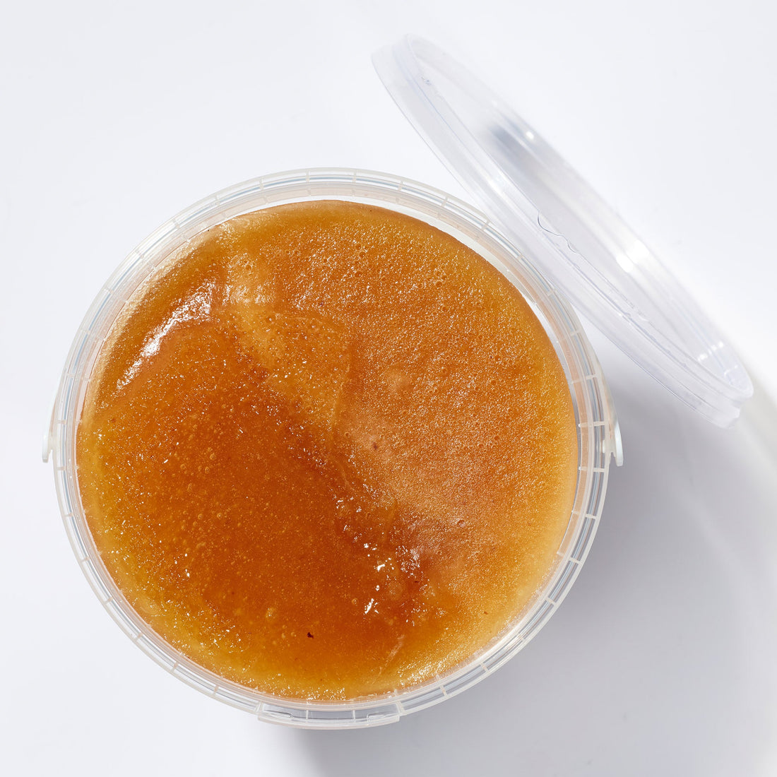 Open tub of Organic Raw Creamed Heather Honey, top view – Earthbreath