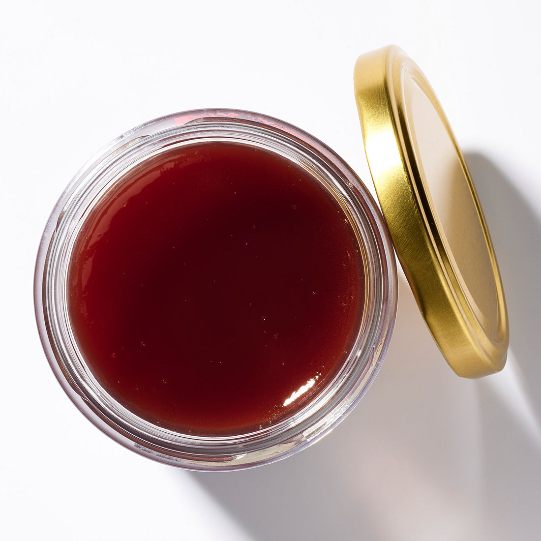Open jar of Raspberries & Honey Marmalade, top view – Earthbreath